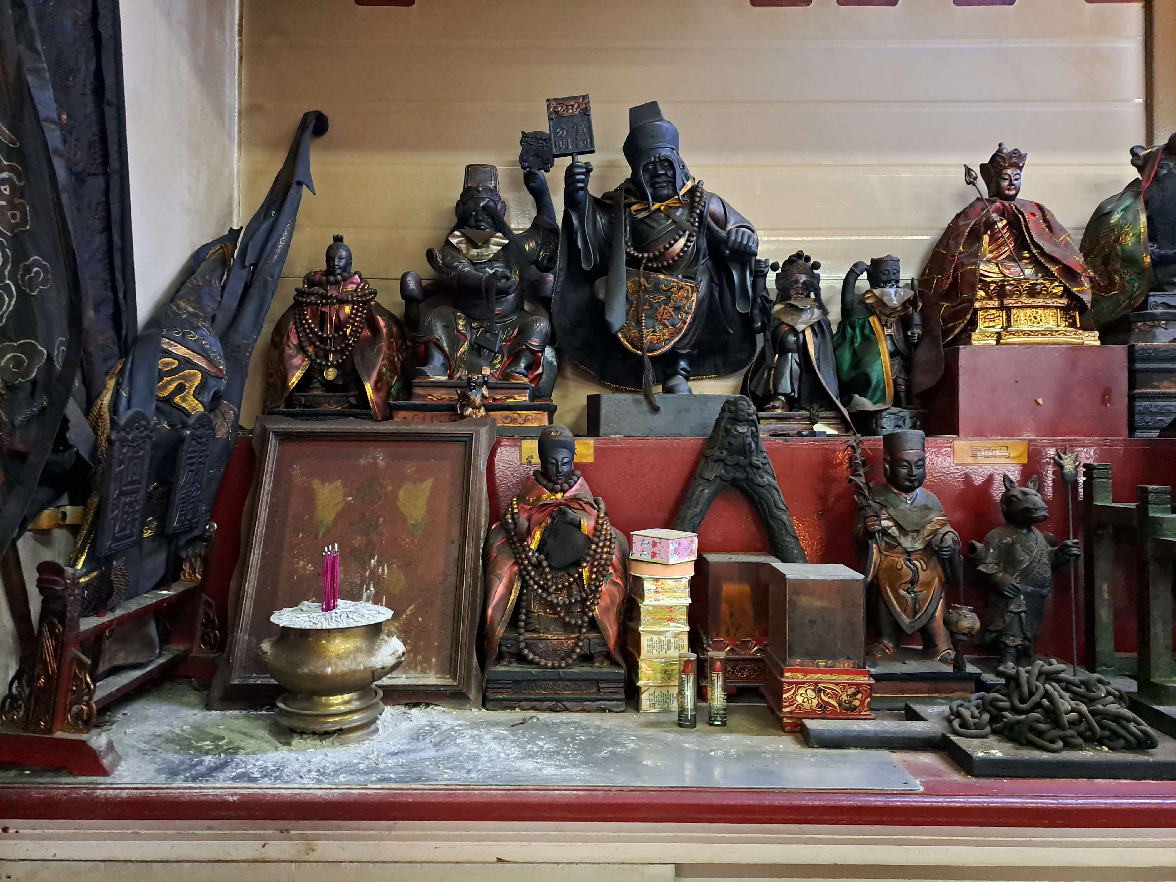 The statues of Lin Guniang (bottom left) and Lei Niangniang (top left corner) on an altar of terrestrial gods at Zhen Long Gong prior to the renovations.. Courtesy of Ng Yi-Sheng.